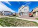 Attractive two-story home has light gray siding, white trim, and stone accents at 803 N Bently St, Watkins, CO 80137