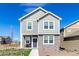 Attractive home with light gray siding, white trim, and stone accents on the facade at 803 N Bently St, Watkins, CO 80137