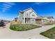 Charming two-story home featuring gray siding, stone accents, and a welcoming front yard at 803 N Bently St, Watkins, CO 80137