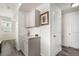 Hallway with built in cabinets, hardwood flooring and ample natural light at 803 N Bently St, Watkins, CO 80137