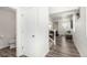 Hallway view with half bathroom and access to upstairs and living room at 803 N Bently St, Watkins, CO 80137