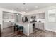 Gray kitchen features stainless steel appliances, an island with bar seating, and ample storage at 803 N Bently St, Watkins, CO 80137