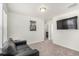 The living room includes modern decor, neutral paint, and a mounted TV for entertainment at 803 N Bently St, Watkins, CO 80137