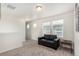 Inviting sitting room with neutral paint, bright lighting, and a comfortable love seat at 803 N Bently St, Watkins, CO 80137