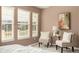 Cozy bedroom sitting area bathed in natural light from three bright windows at 14215 W 84Th Pl, Arvada, CO 80005