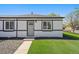 Charming front exterior with a well-maintained lawn, accented by fresh mulch at 3200 N Elizabeth St, Denver, CO 80205