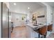 Modern kitchen featuring stainless steel appliances, white cabinetry, and convenient breakfast bar at 3200 N Elizabeth St, Denver, CO 80205