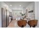 Well-lit kitchen with stainless steel appliances, breakfast bar, and ample counter space at 3200 N Elizabeth St, Denver, CO 80205