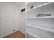 Neat laundry room space with white shelving offering ample storage at 3200 N Elizabeth St, Denver, CO 80205