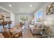 Cozy living room with open floor plan to kitchen, featuring a large window and modern furnishings at 3200 N Elizabeth St, Denver, CO 80205