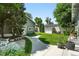 Landscaped backyard offers a serene escape with a winding pathway, lush lawn, and a charming shed at 1451 S Columbine St, Denver, CO 80210