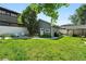 Spacious backyard features a lawn, patio with outdoor seating, and charming storage shed at 1451 S Columbine St, Denver, CO 80210