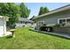 Lush backyard features a green lawn, landscaping, a stone walkway and two outbuildings at 1451 S Columbine St, Denver, CO 80210