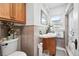 Charming bathroom featuring neutral tile and a wooden vanity at 1451 S Columbine St, Denver, CO 80210
