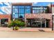 Street view of commercial building with brick and glass exterior, modern design, and landscaped entrance at 1451 S Columbine St, Denver, CO 80210