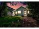 Charming home featuring a well-maintained lawn, garden beds, and a brick pathway to the front door at 1451 S Columbine St, Denver, CO 80210