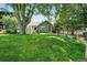 View of a home with a sprawling green lawn and mature trees at 1451 S Columbine St, Denver, CO 80210