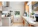 Bright kitchen featuring stainless steel appliances, light wood cabinetry, and a garden window at 1451 S Columbine St, Denver, CO 80210