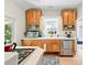 Bright kitchen featuring wooden cabinetry, stainless steel appliances, and a garden window at 1451 S Columbine St, Denver, CO 80210