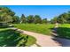 Expansive park view with walking paths, green grass, and mature trees at 1451 S Columbine St, Denver, CO 80210