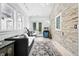 Cozy sunroom with stone accent wall, light wood flooring, and ample natural light at 1451 S Columbine St, Denver, CO 80210