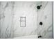 Bathroom with new white marble tiled shower, black plumbing fixtures, and recessed niche at 956 S Peoria St, Aurora, CO 80012