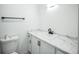 Bathroom featuring a modern sink with granite countertop, new toilet and black towel bar at 956 S Peoria St, Aurora, CO 80012