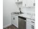 Close up of modern kitchen featuring stainless steel appliances, marble countertop, and white cabinets at 956 S Peoria St, Aurora, CO 80012