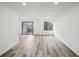 Open living room featuring new flooring, recessed lighting, and glass patio door to balcony at 956 S Peoria St, Aurora, CO 80012