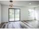 Bright living room with new floors, modern lighting, a large window, and a glass patio door at 956 S Peoria St, Aurora, CO 80012