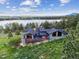 Aerial view of a stunning lakefront home with a spacious deck and scenic surroundings at 3021 N Lakeridge Trl, Boulder, CO 80302