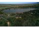 Aerial view of a home with a lake view surrounded by mature trees at 3021 N Lakeridge Trl, Boulder, CO 80302