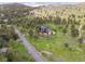 Aerial view of a home nestled within a lush, green landscape at 3021 N Lakeridge Trl, Boulder, CO 80302