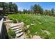 Backyard features a stone walkway and mature trees at 3021 N Lakeridge Trl, Boulder, CO 80302