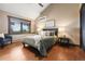 Cozy bedroom featuring hardwood floors, a large window with scenic views, and comfortable decor at 3021 N Lakeridge Trl, Boulder, CO 80302