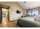 Cozy bedroom with wood floors, a reading chair, and natural light at 3021 N Lakeridge Trl, Boulder, CO 80302