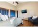 Bright bedroom features wood floors, vaulted ceiling, and a flatscreen TV at 3021 N Lakeridge Trl, Boulder, CO 80302