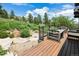 Outdoor deck area features a wooden table and views of the surrounding landscape at 3021 N Lakeridge Trl, Boulder, CO 80302
