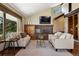 Inviting living room featuring a brick fireplace, large windows, and comfortable seating area at 3021 N Lakeridge Trl, Boulder, CO 80302