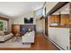 Bright living room with a brick fireplace, open layout, and seamless integration with the kitchen at 3021 N Lakeridge Trl, Boulder, CO 80302