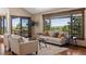 Living room with vaulted ceilings and scenic views from the expansive windows at 3021 N Lakeridge Trl, Boulder, CO 80302