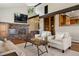 Inviting living room with a cozy brick fireplace and comfortable seating at 3021 N Lakeridge Trl, Boulder, CO 80302