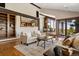 Open-concept living room with a fireplace, built-in shelves, and hardwood floors at 3021 N Lakeridge Trl, Boulder, CO 80302
