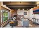 Cozy living room with exposed beams, brick fireplace, and stylish contemporary furnishings at 3021 N Lakeridge Trl, Boulder, CO 80302