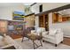Inviting living room featuring a brick fireplace, large windows, and comfortable seating area at 3021 N Lakeridge Trl, Boulder, CO 80302