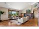 Bright living room with a brick fireplace, large windows offering scenic views, and modern decor at 3021 N Lakeridge Trl, Boulder, CO 80302