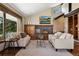 Inviting living room featuring a brick fireplace, large windows, and comfortable seating area at 3021 N Lakeridge Trl, Boulder, CO 80302