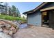 Stone patio features natural stone accents and a sliding glass door at 3021 N Lakeridge Trl, Boulder, CO 80302