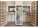 Organized walk-in closet with custom shelving and a center mirror offers great storage and functionality at 3021 N Lakeridge Trl, Boulder, CO 80302