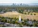 Home with a view of the Denver skyline surrounded by vibrant trees, providing a unique urban oasis at 3674 Dexter St, Denver, CO 80207